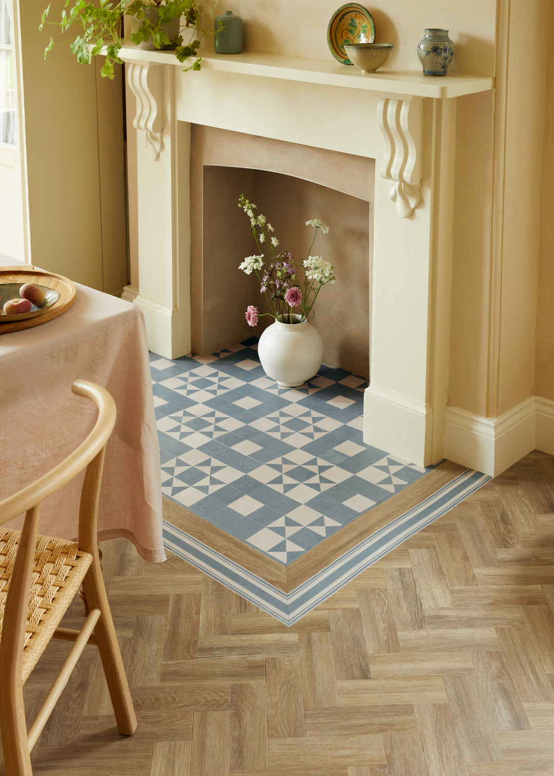 Room interior with a fireplace, patterned rug, and decorative items.