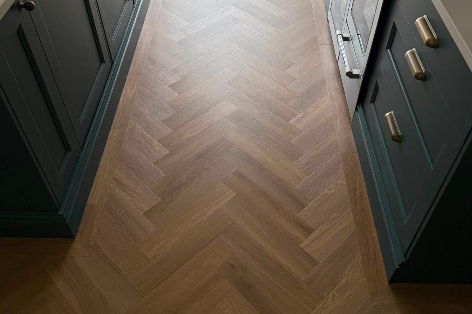 Amtico Spacia Wilton Oak parquet flooring with a single-plank border in a Cornish cottage kitchen
