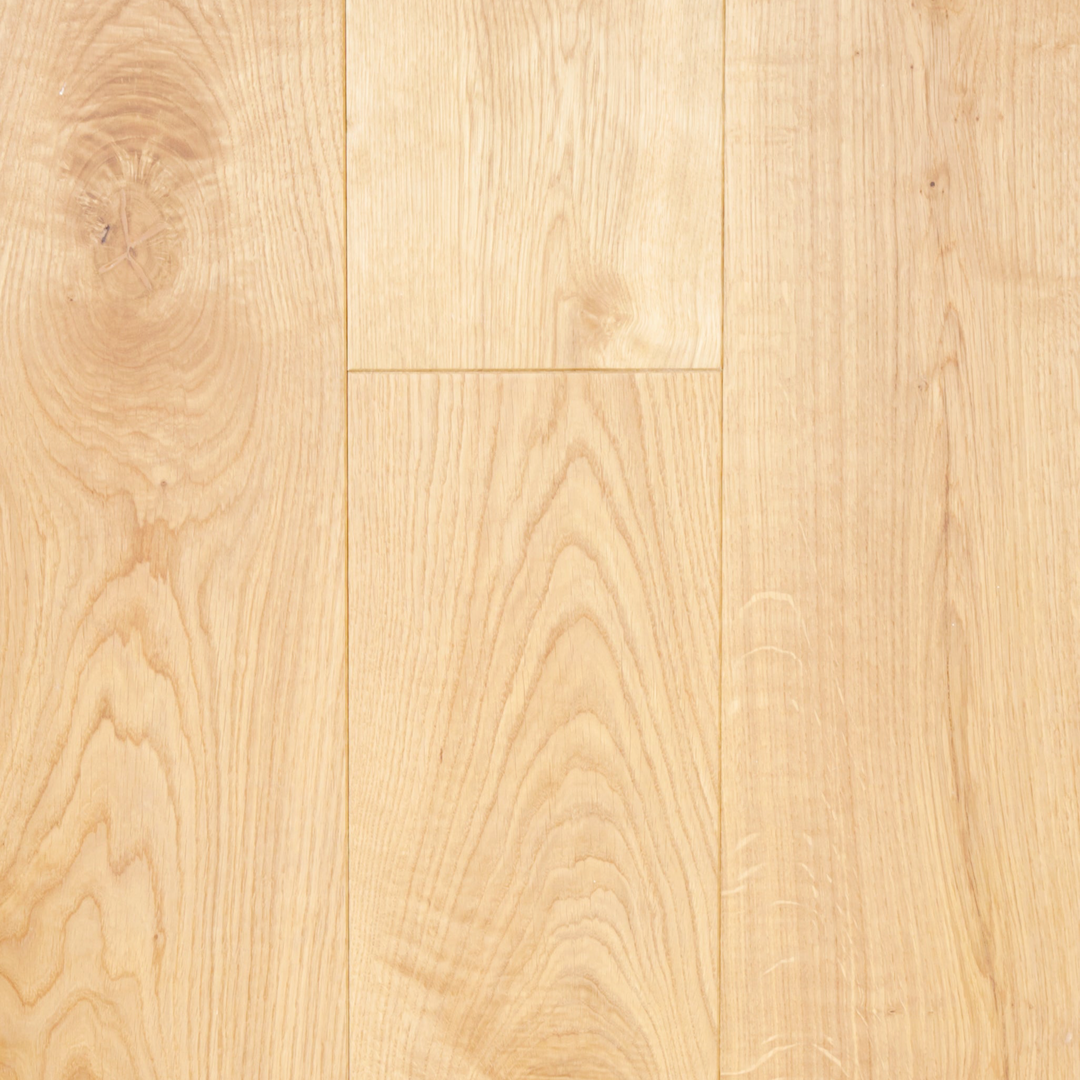 Close-up of a wooden floor with a light brown color and visible grain pattern.