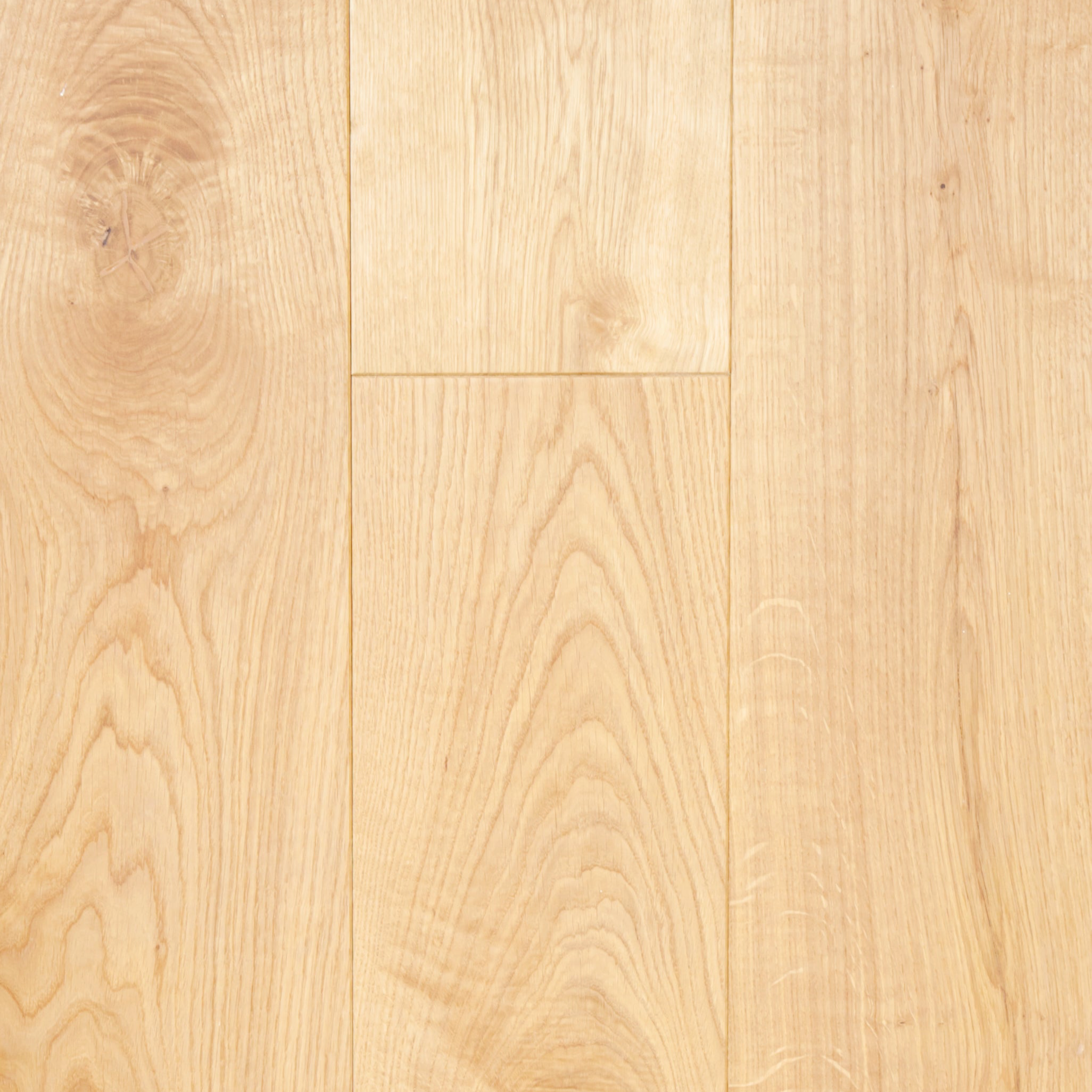 Close-up of a wooden floor with a light brown color and visible grain pattern.
