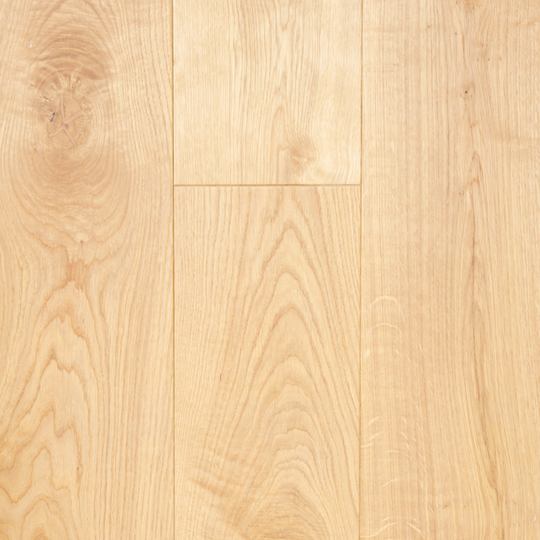 Close-up of a wooden floor with a light brown color and visible grain pattern.