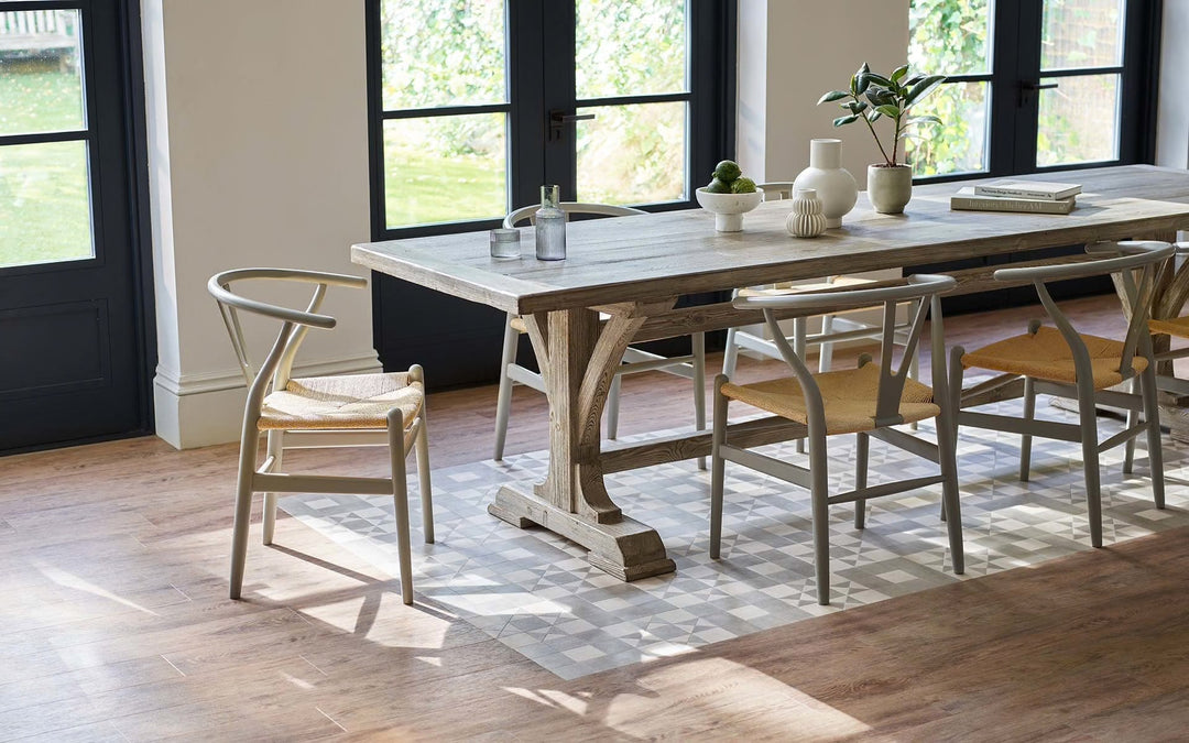 Dining room with a large wooden table and chairs on a wooden floor.