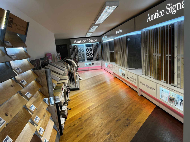 Display of Amtico flooring samples and products in a showroom.
